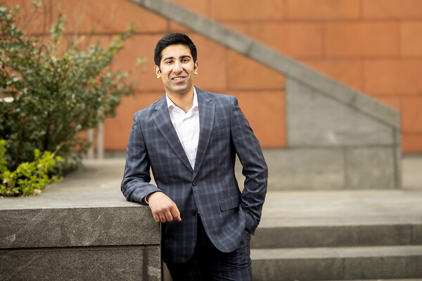 Ayaan Jeraj wears a suit while standing outside Huntsman Hall.