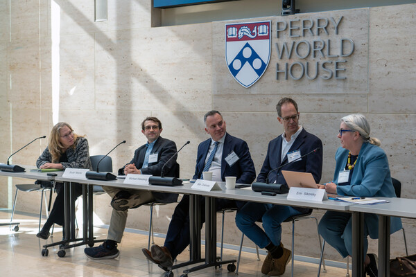 A panel of speakers seated at Perry World House.